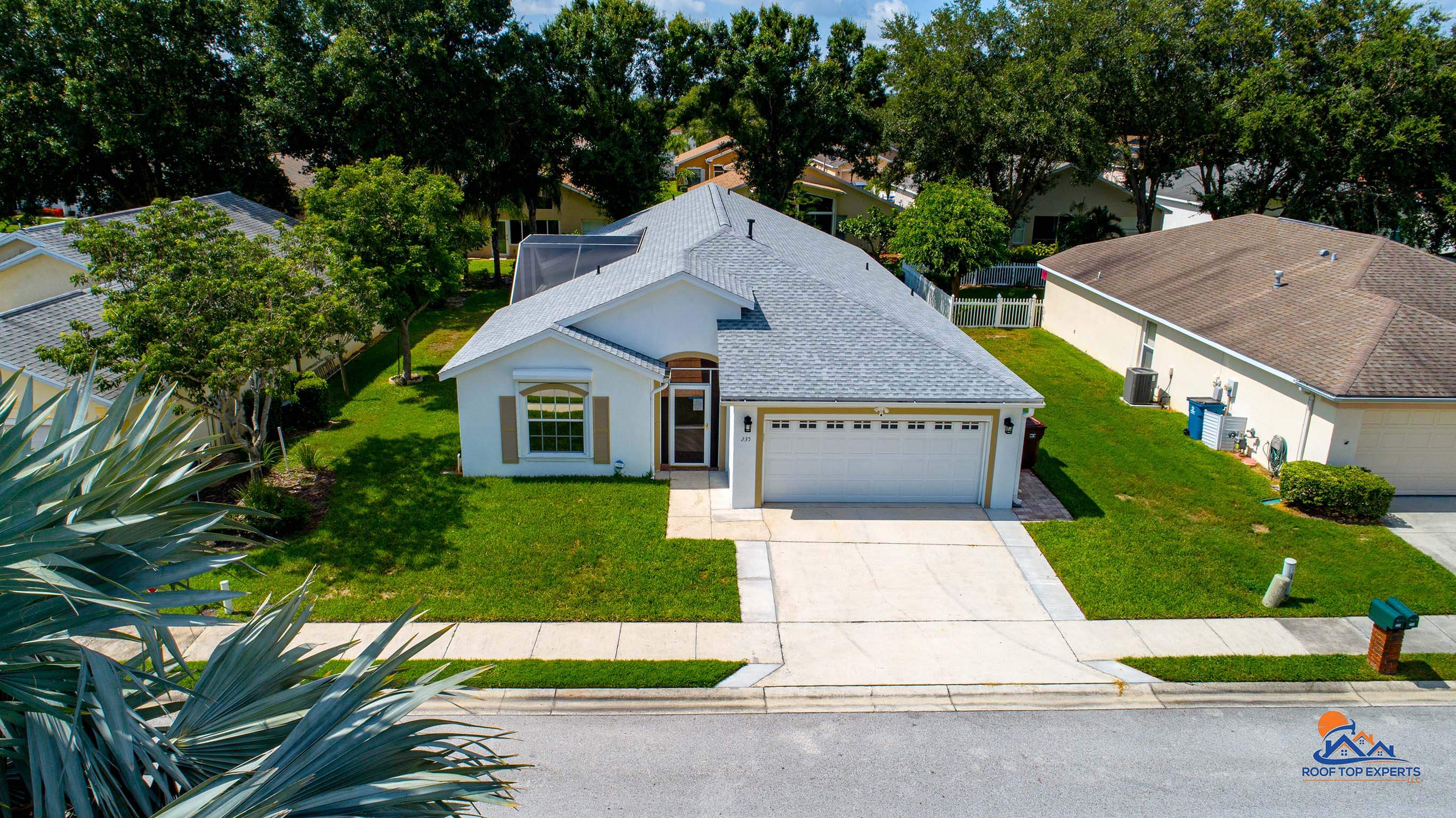 Residential roof replacement featuring a GAF roofing system in Birchwood color, providing durable and stylish protection for homes.