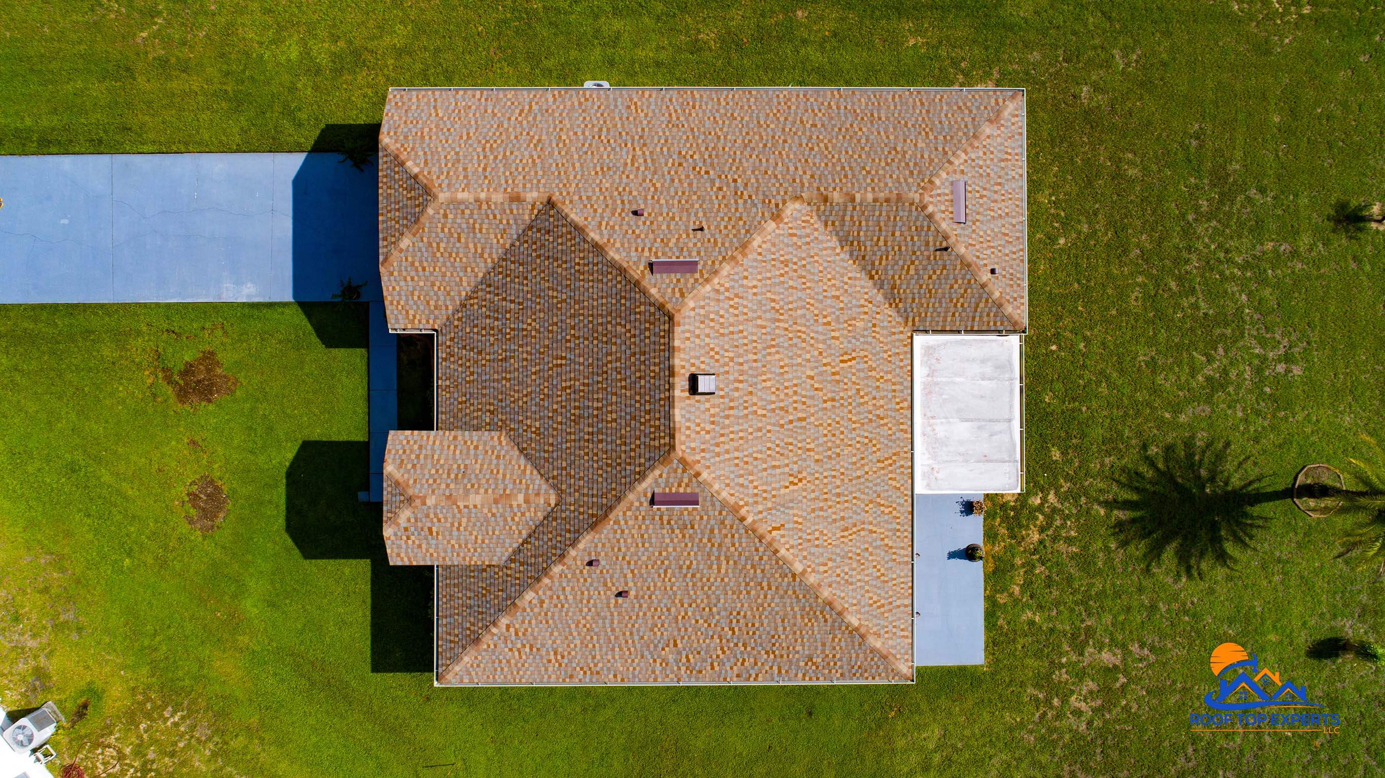 Top Down Aerial view of a GAF Golden Harvest shingles on a residential roof, showcasing a completed roof replacement.